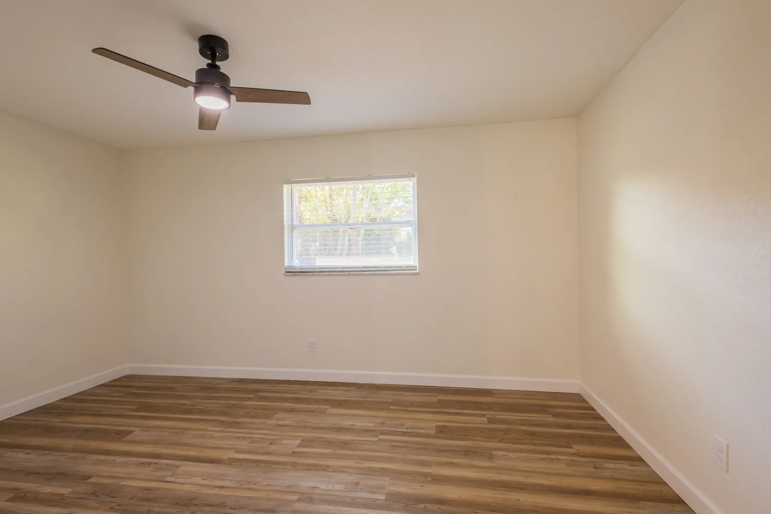 Unfurnished bedroom with wood-look floors