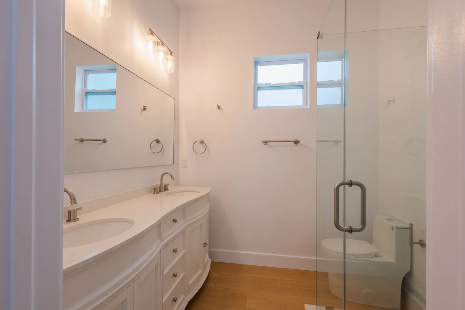 White bathroom vanity and glass shower