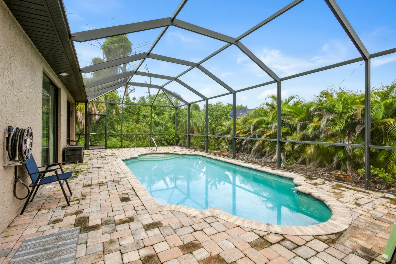Screened swimming pool and shaded patio