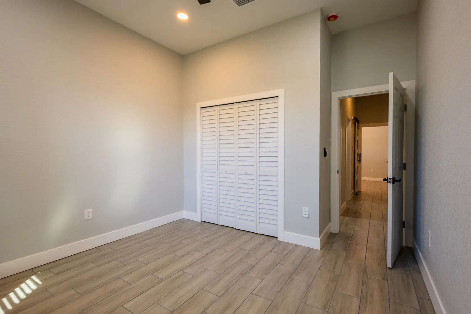Quiet bedroom with wood-look floors