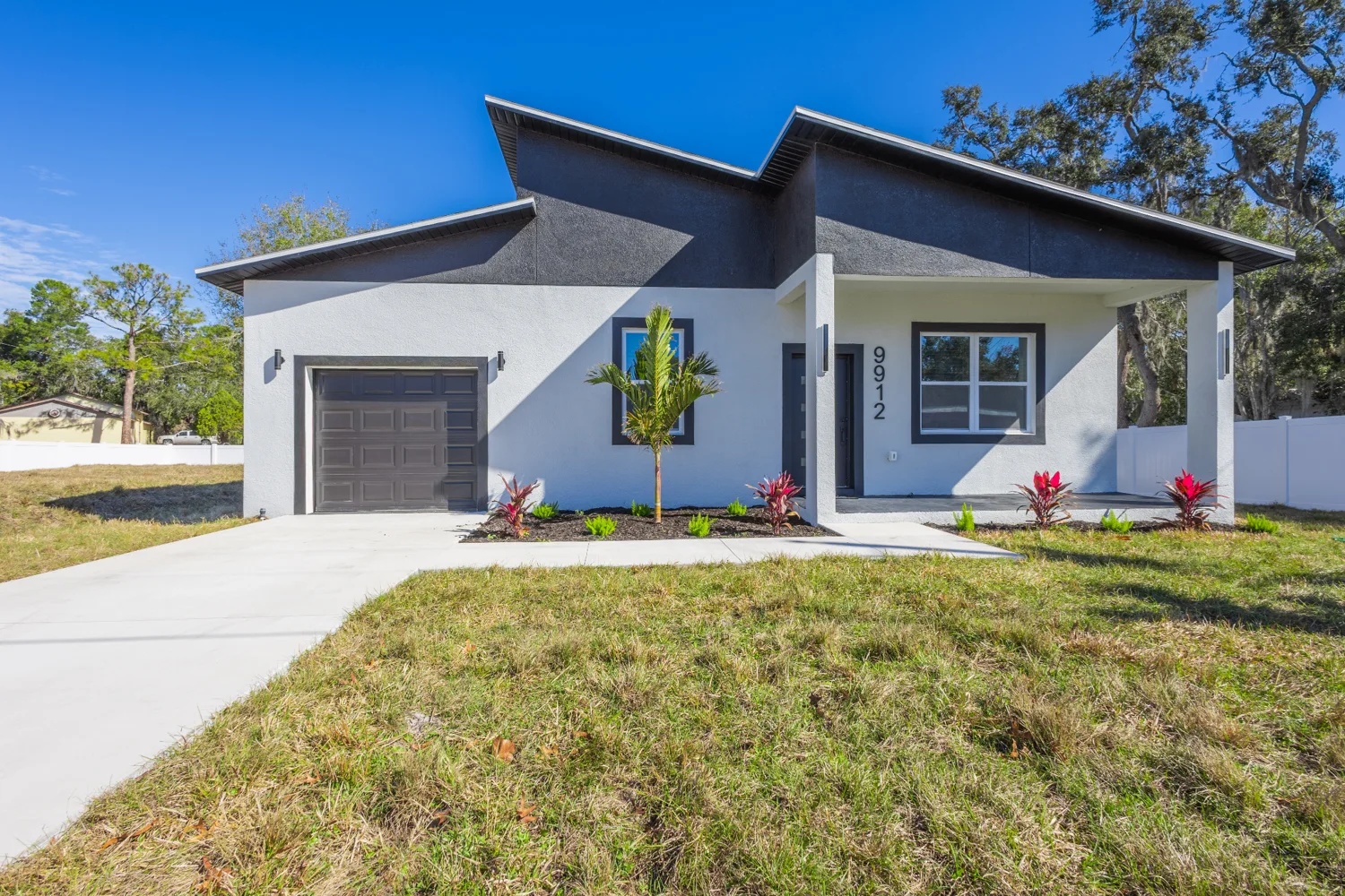 Home exterior and driveway under blue skies
